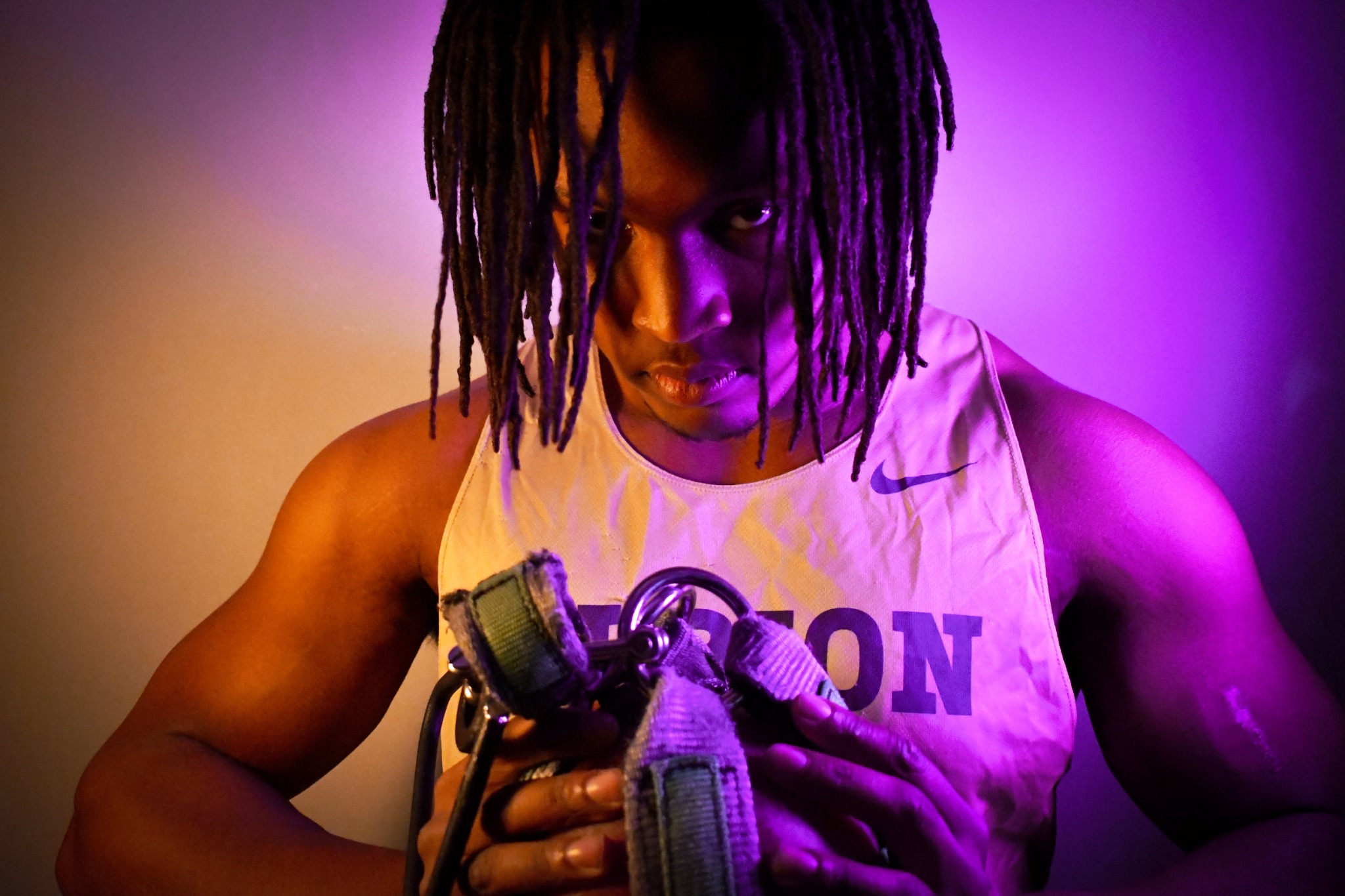 Dramatic Albion athlete portrait lit with purple and amber light