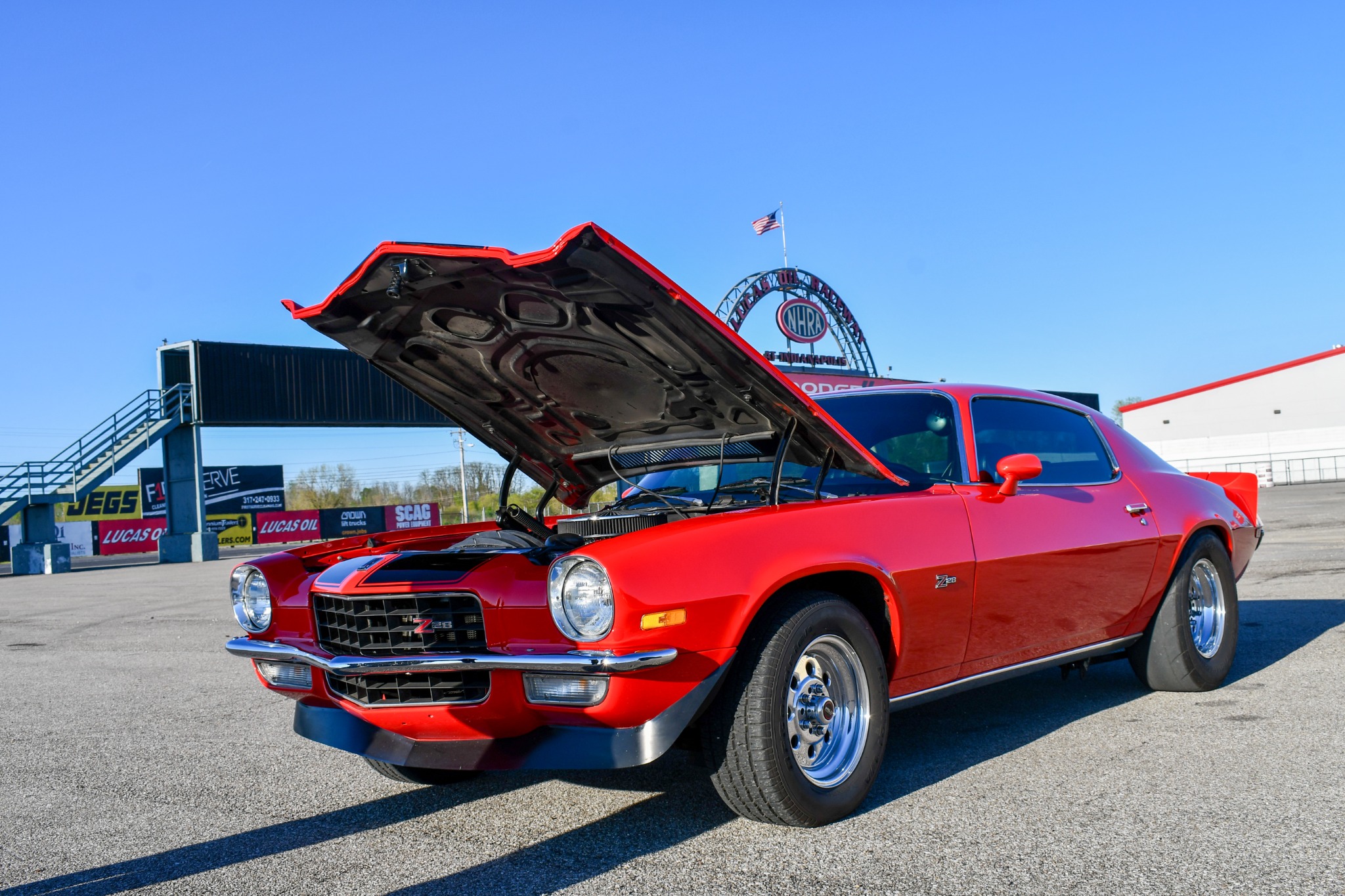 Red classic performance car photographed at Lucas Oil Indianapolis Raceway Park