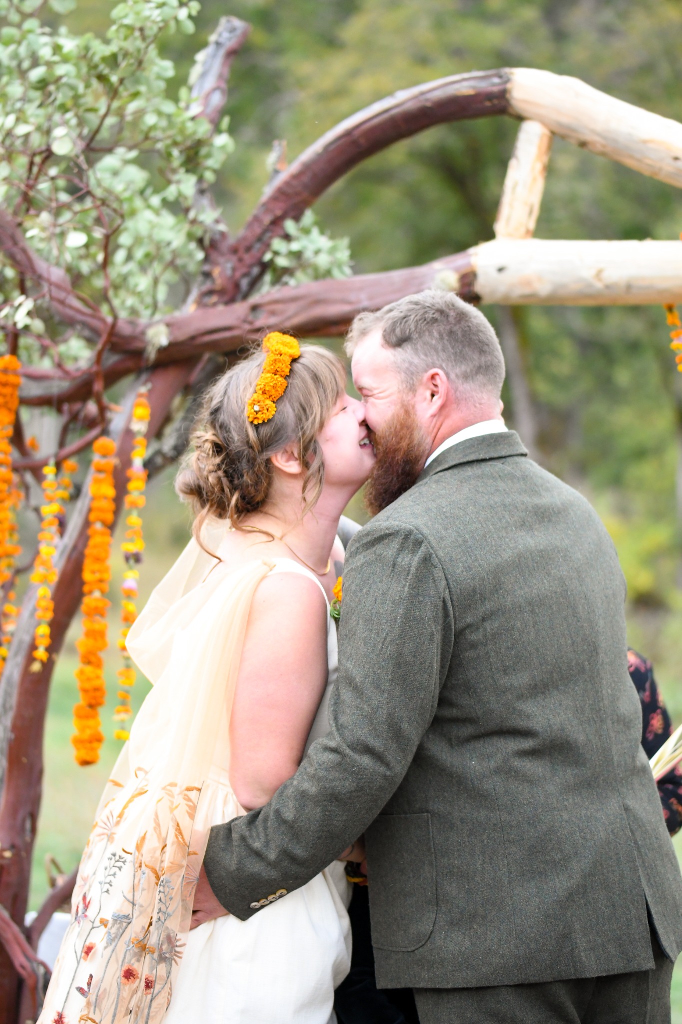 Bride embracing a child during an outdoor wedding